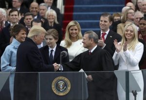 U.S. President Donald Trump shakes hands with U.S. Supreme Court Chief Justice John Roberts (R) after being sworn in as president with his wife Melania, and children Barron, Donald, Ivanka and Tiffany at his side during inauguration ceremonies at the Capitol in Washington, U.S., January 20, 2017. REUTERS/Carlos Barria